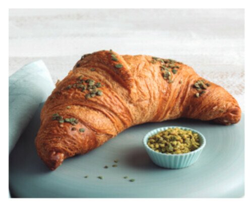 Gran Croissant Pistaccho. Croissant con levadura natural relleno de crema de pistacho y decorado con avena